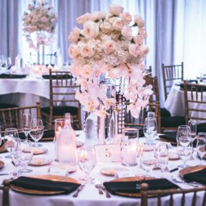 A luxurious wedding dining setup with elegant floral centerpieces and candlelight ambiance.