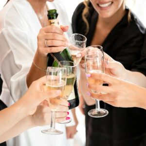 Women Celebrating and Holding Wineglasses and Champagne