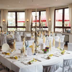 A beautifully arranged dining room with elegant table settings ready for a special event or celebration.